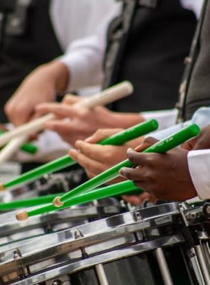 Green drumsticks on snare drums, close up